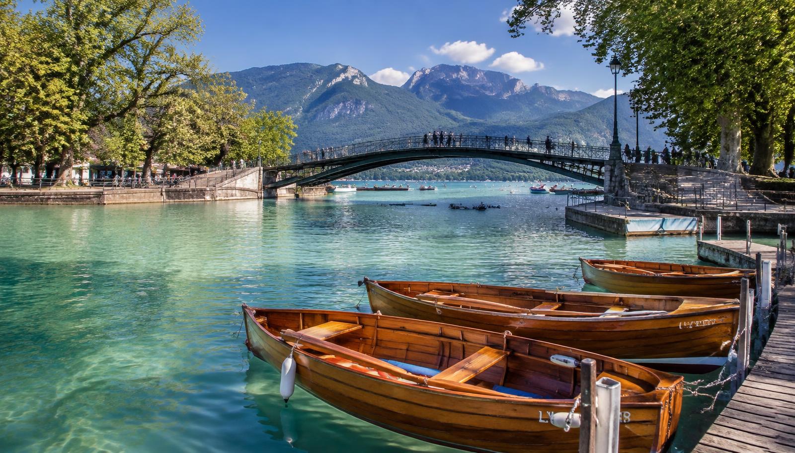 Barques en bois sur le lac d'Annecy devant le Pont des Amours
